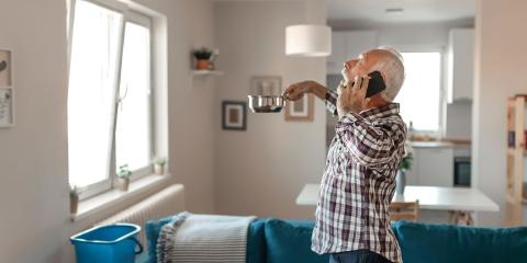 Personne qui contacte son assureur à cause d'une fuite de toiture