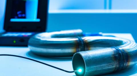 Extrémité lumineuse d’une caméra endoscopique explorant l’intérieur d’un tuyau en métal, utilisée pour l’inspection des canalisations – prix et avantages.